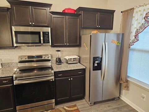 Fully equipped kitchen with modern appliances, ample cabinet space, and clean countertops—perfect for preparing meals and enjoying everyday cooking.
