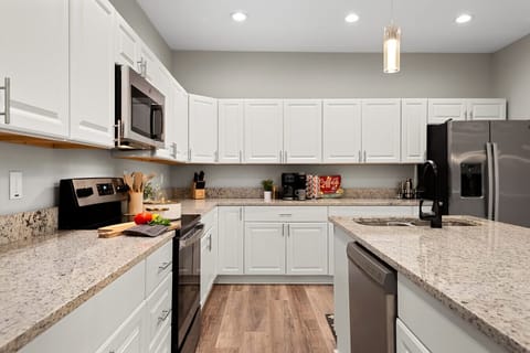 Expansive Eat-In Kitchen: Whip up a feast with modern GE appliances and plenty of counter space before gathering everyone around the grand dining table.