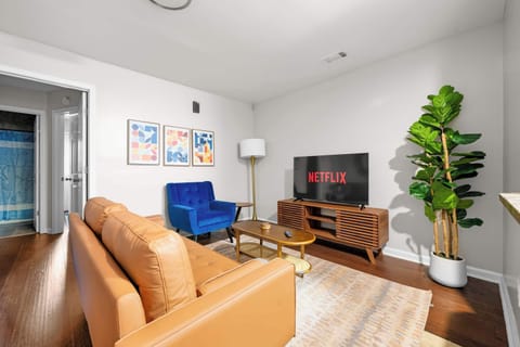 A bright, airy workspace environment with plenty of natural light and a large Smart TV for a seamless transition from work to play.