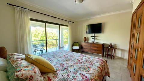 Master Bedroom featuring a king size bed with direct access to peaceful balcony.