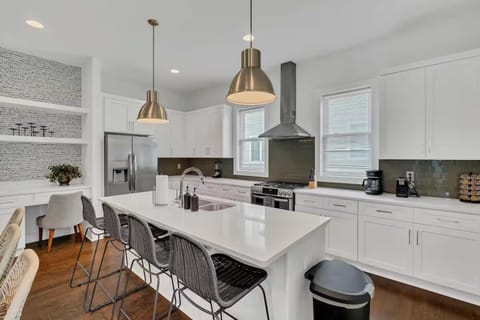 Open-concept kitchen with quartz counters, gas range, and stainless appliances.| Unit C