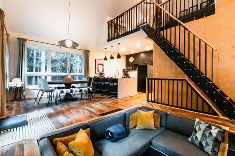 Conversation pit, dining, kitchen, and loft view at the Carpenter's Cabin
