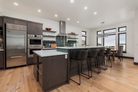 Your chef-worthy kitchen features premium appliances, spacious island seating for four, and sleek modern design perfect for memorable meals together.
