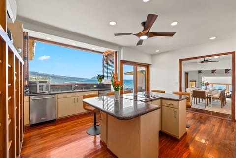 Cook while gazing at stunning ocean views from your fully equipped kitchen with sleek granite island and premium appliances.