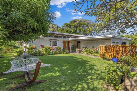 Private front yard with outdoor covered dining table to right of front door