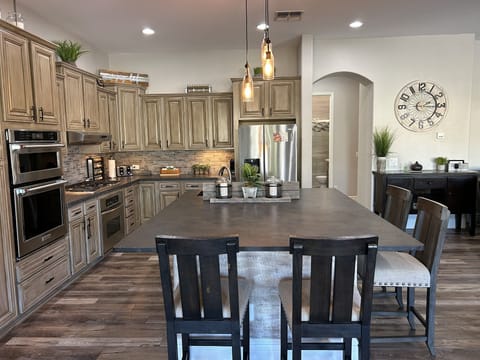 Open concept kitchen is open to living room and game room.
