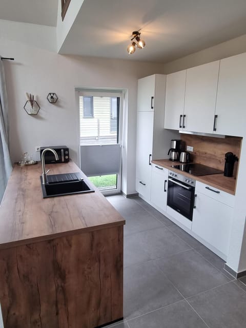 Modern kitchen with wooden countertop and appliances