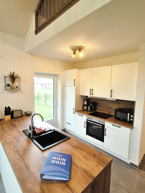 Modern kitchen with wooden countertop and appliances