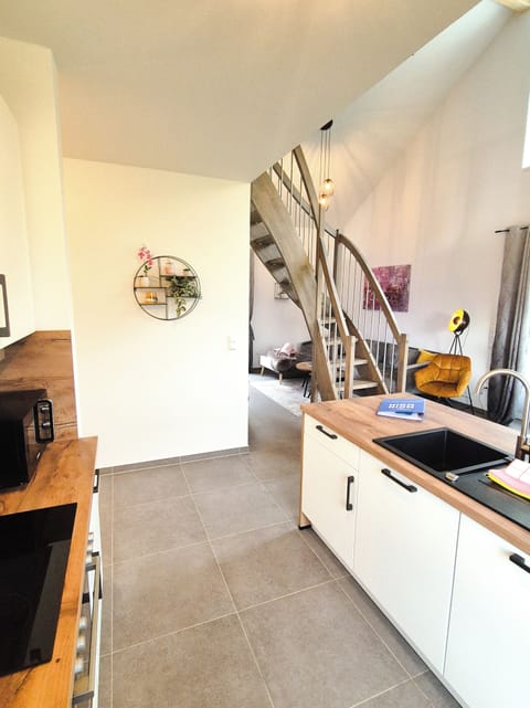 Modern Kitchen with Wood Worksurface and Stairs