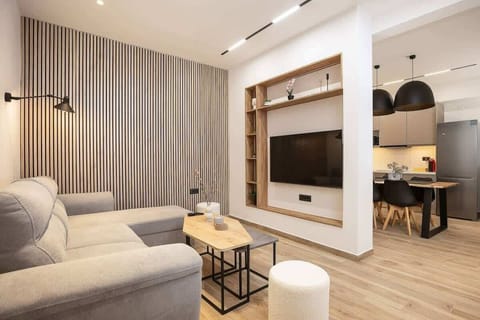 Bright Living Area with Comfortable Seating – Spacious open plan with sofa and natural light.