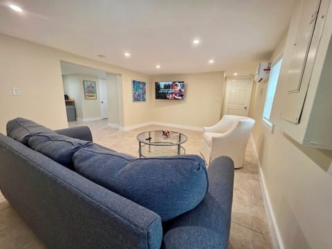 Comfortable living room offering cozy seating and a wall-mounted TV.