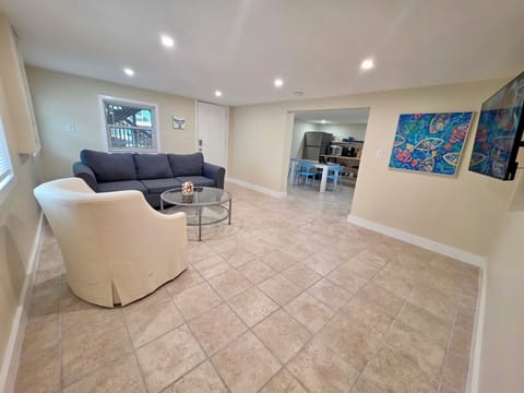 Comfortable living room offering cozy seating and a wall-mounted TV.