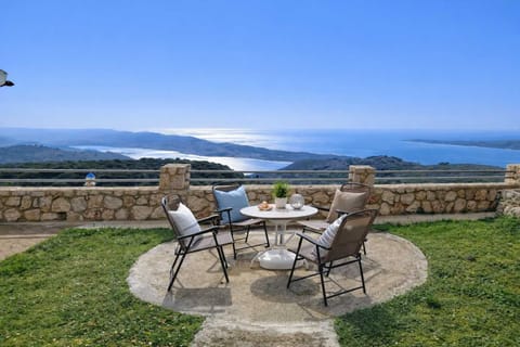 Panoramic Garden Seating with Sea Views
Outdoor dining table set on stone terrace overlooking the bay and coastline.