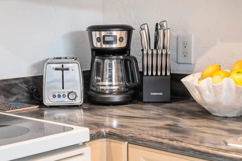 Coffee station with a full coffee maker, mugs, and essentials—perfect for starting your mornings with ease.