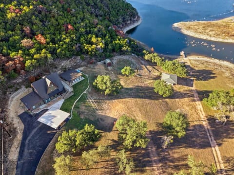 Aerial view showcasing the home, grounds, and surrounding natural beauty.