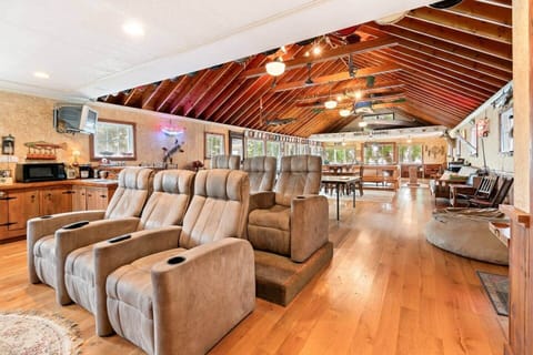 Spacious entertainment lounge with theater seating, vaulted ceilings, and plenty of room to relax or gather with friends and family