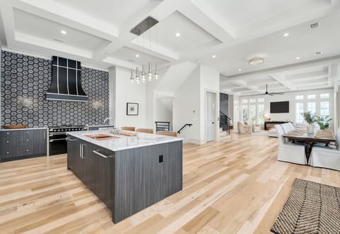 Stunning open-concept kitchen with marble island flows into your bright living space, creating the perfect gathering spot.