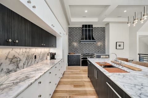 Your gourmet kitchen awaits with marble counters, professional appliances, and an elegant island perfect for culinary adventures.