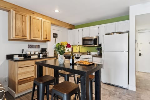 Dining island set for a meal, showcasing the warm wood cabinetry.