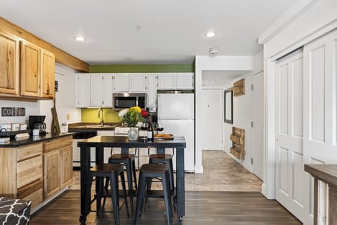 View of the kitchen and breakfast bar from the living area entry.