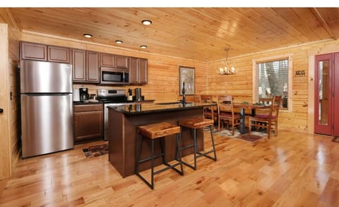 Step into your cozy cabin kitchen where rustic wood meets modern convenience—perfect for creating memorable meals together.