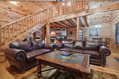 Sink into plush leather sofas surrounded by warm wood walls and beams that create your perfect mountain retreat atmosphere.