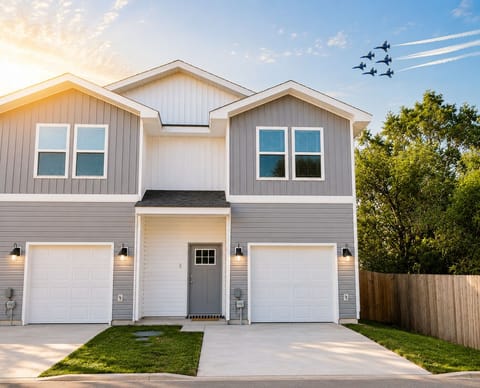 Modern duplex with private garage, fresh curb appeal, and bright exterior