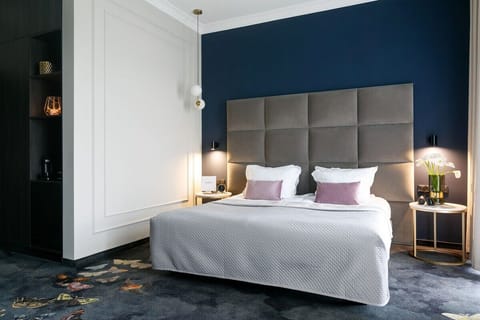Sink into a serene bed framed by elegant, moody tones.