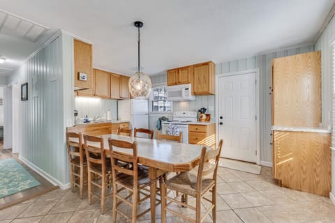 Your open kitchen and dining space features warm wood cabinetry, modern appliances, and a cozy dining table where memorable meals begin.