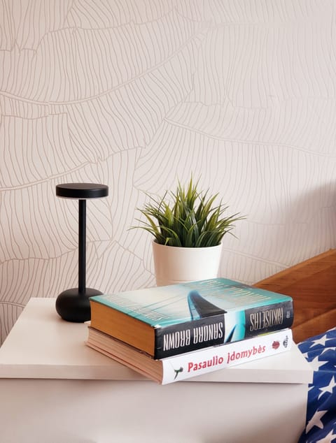 Table lamps are placed around the apartment to create warm atmosphere