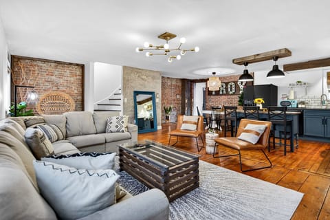 Historic brick, wide-plank floors & a massive sectional for group movie nights.