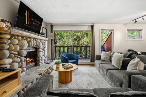 Main floor living room with a Smart TV with cable, board games, cozy seating options, and a decorative fireplace (fireplace can not be used).