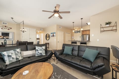 Sink into plush leather sofas in your open-concept living space, where modern comfort meets home-style convenience.