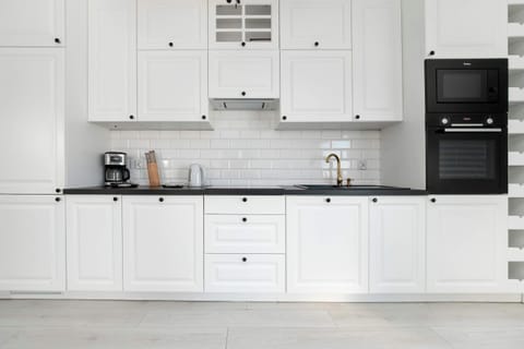 The sleek design of the kitchenette blending seamlessly with the living area.