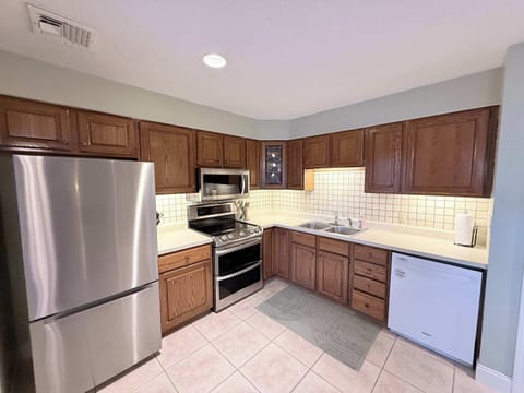 Full kitchen with dining table and deck access