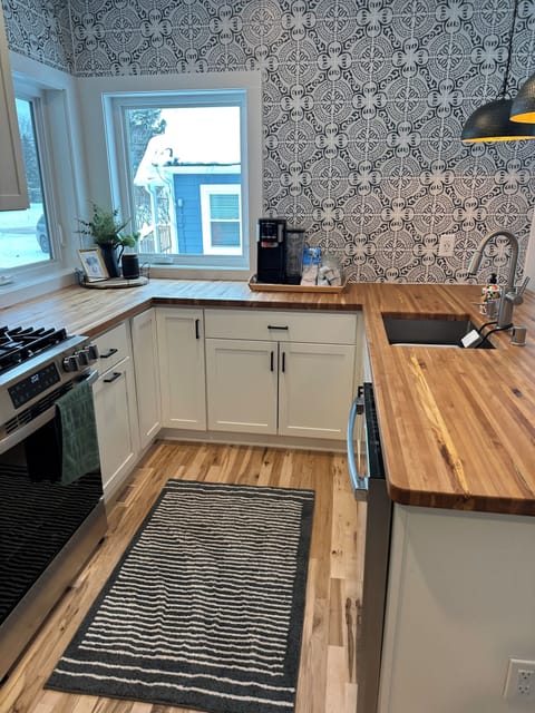 Custom kitchen w/ handcrafted countertops and all appliances and fully stocked.