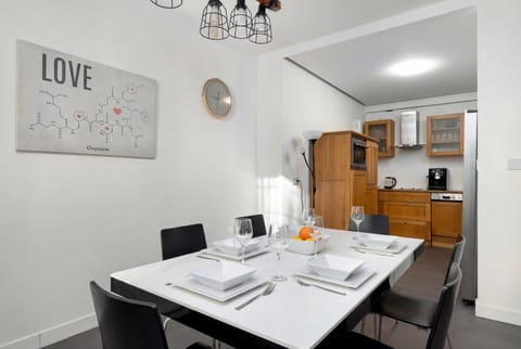 Dining table set in the center of the open living space.