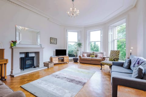 Living Room Oasis: Elegant space with bay windows, plush seating, and charming décor awaits you!