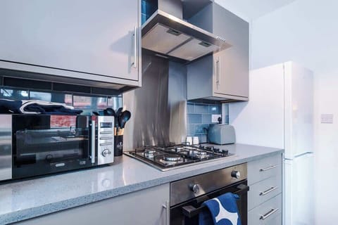 Kitchen: Modern design with sleek appliances and a pop of color for your culinary adventures!