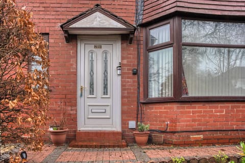 Charming Entrance: Step into comfort with a welcoming front door and classic brick façade!