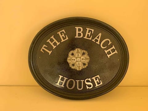 Welcome Sign: Embrace beachside charm with a warm welcome at The Beach House!
