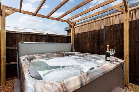Hot Tub Retreat: Unwind and indulge in luxury with bubbly and serene surroundings!