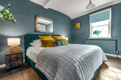 Charming Bedroom: Bright, stylish space with plush bedding and vibrant decor for ultimate relaxation!