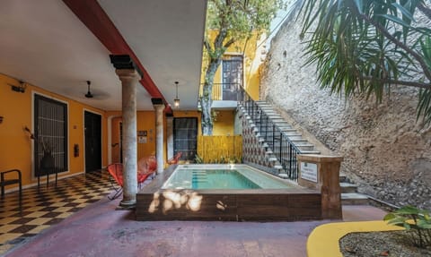 Step into a sunlit courtyard pool framed by historic stonework.