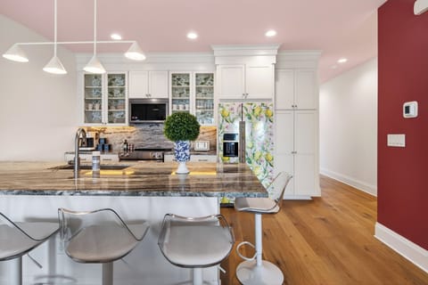Bright kitchen with island seating and modern appliances.