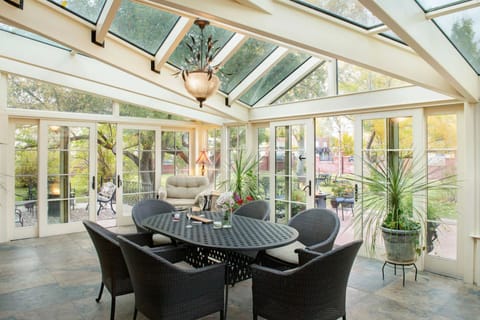 Unwind under soaring skylights in this serene, sunlit conservatory.
