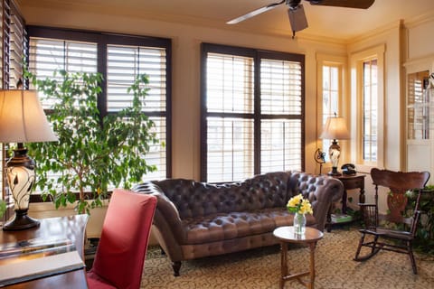 Lounge in plush comfort as sunlight pours through shuttered windows.