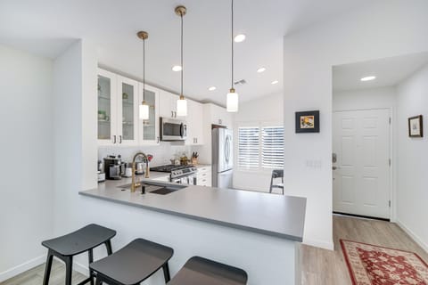 Cook together in this bright, modern kitchen with sleek granite counters, stainless appliances, and pendant lighting creating the perfect culinary experience.