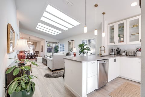 Your bright open-plan space flows seamlessly from kitchen to living area, bathed in natural light from the stunning skylight above.