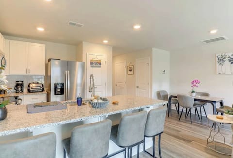 Fully Equipped Chef's Kitchen: Save money on takeout! This modern kitchen features stainless steel appliances, granite countertops, and a large island perfect for meal prep or laptop work. Includes a dedicated coffee station to start your shift right